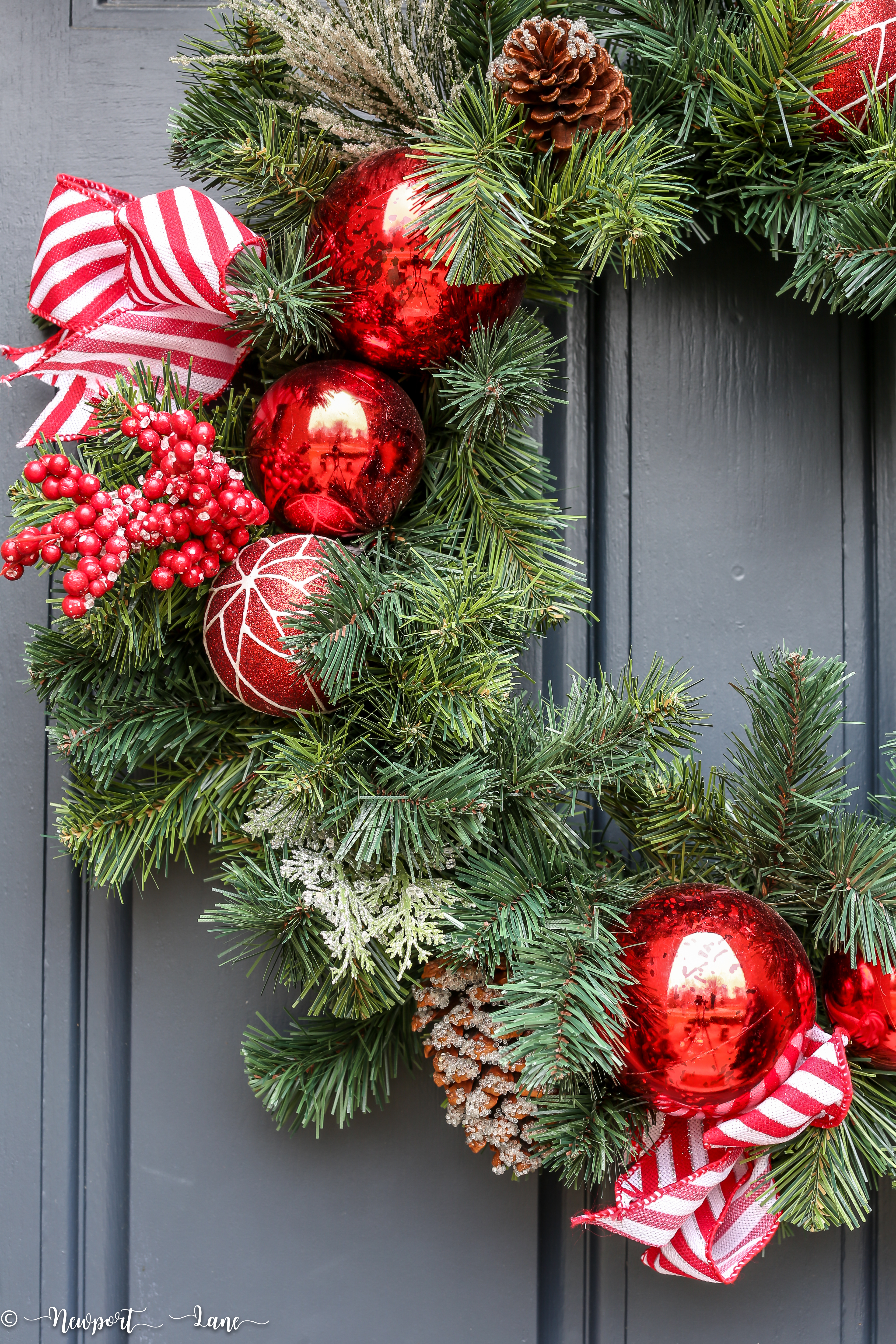 Christmas front porch decor. Red and green decorations. Red lanterns. #Christmasfrontporch #Christmasdecor #holidaydecor