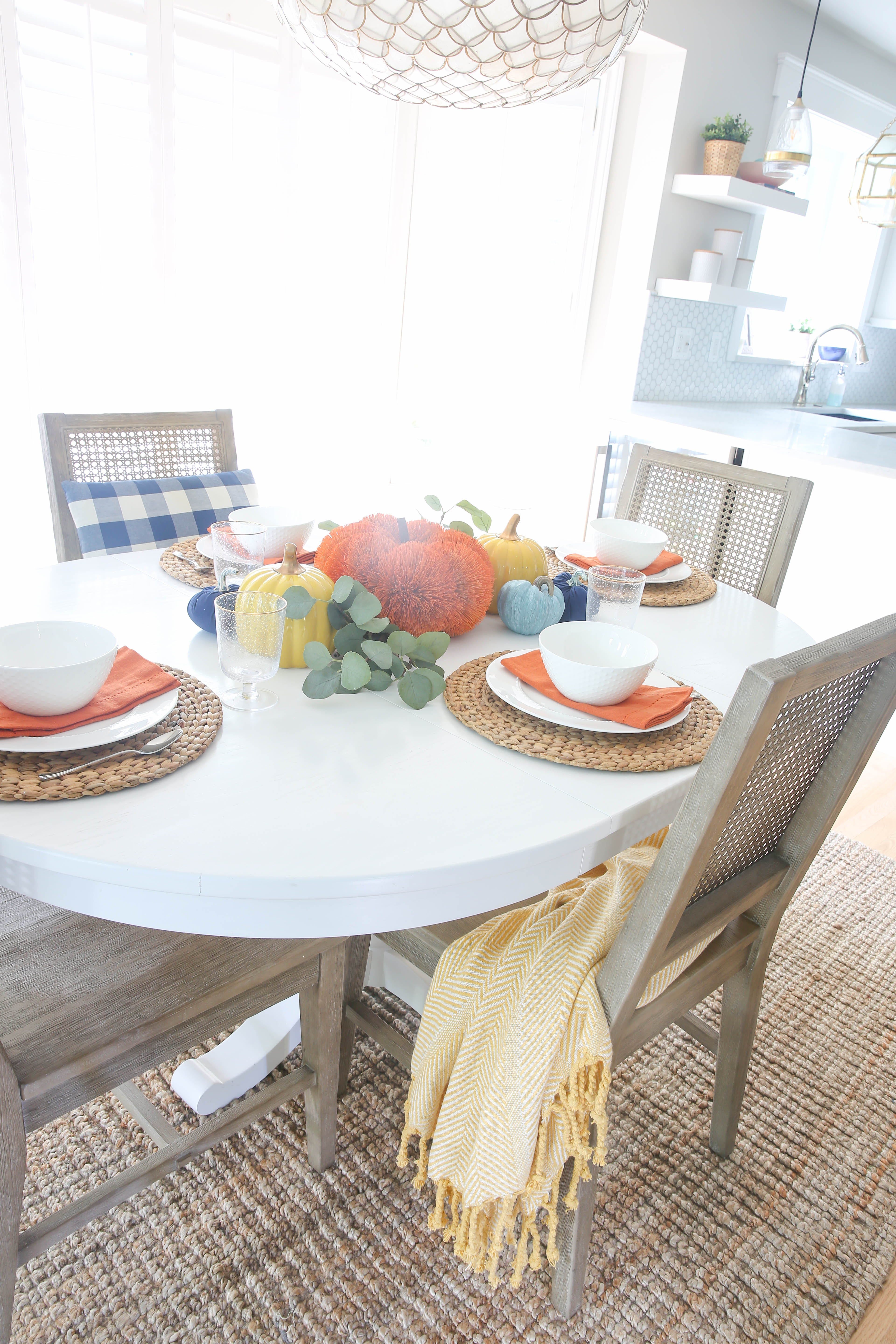 Beautiful + simple orange, yellow and blue fall centerpiece ideas. Read this post for simple + easy ideas for a fall tables cape. #fall #simple #tablescape #centerpiece